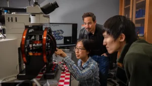 Itai Cohen, center, professor of Physics and Design Tech, works with Melody Lim, left, and Zexi Liang, right, at Cohen’s lab in the Physical Sciences Building.